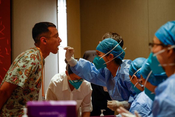 epa10635454 A journalist undergoes a Covid-19 PCR test ahead of the China-Central Asia Summit welcome ceremony at a hotel in Xi'an, Shaanxi province, China, May 18, 2023. The heads of state of Kaz...