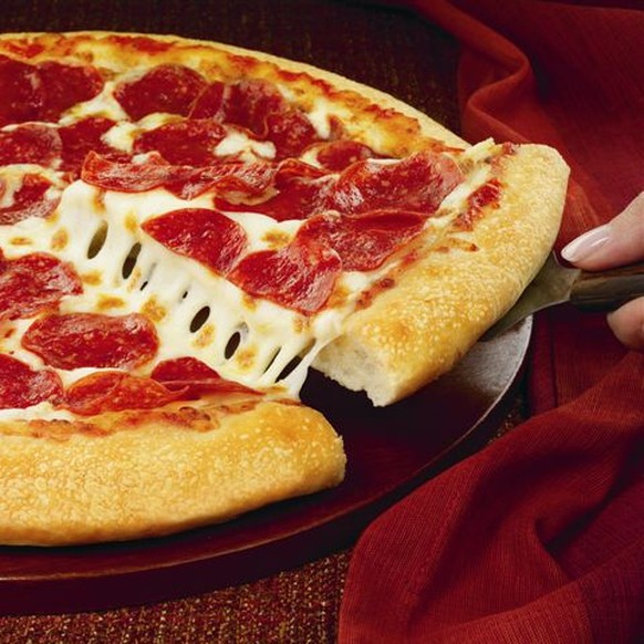 This handout photo provided by Pizza Hut, shows a hand-tossed pizza. Pizza Hut announced Monday, Jan. 13, 2014, it plans to start offering pizza by the slice for the first time in two test locations t ...