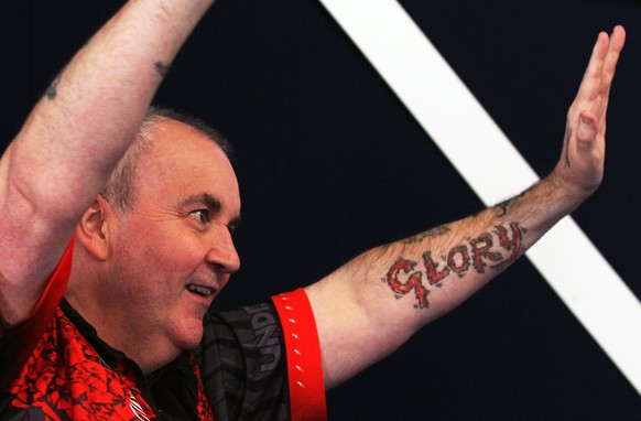 epa06413068 Phil Taylor of England reacts during his PDC World darts final match against Rob Cross of England (not seen) at the Alexander Palace in North London, Britain, 01 January 2018. EPA/SEAN DEM ...