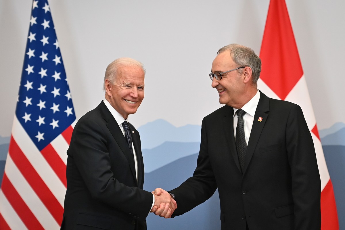 US President Joe Biden, left, attends a bilateral meeting with Swiss president of the Swiss confederation Guy Parmelin, right, ahead of a meeting with Russian counterpart Vladimir Putin in Geneva, Swi ...