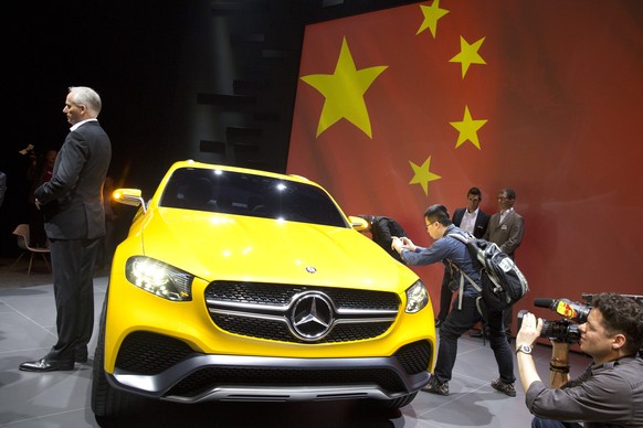 In this photo taken April 19, 2015, journalists take photos and video of the Mercedes Benz concept GLC Coupe unveiled ahead of the Auto Shanghai show in Shanghai. A Chinese regulator said Thursday, Ap ...