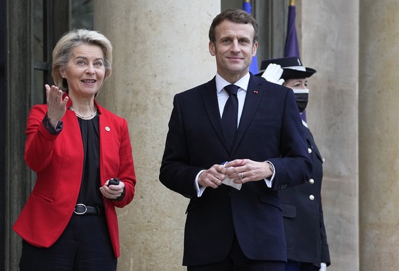 French President Emmanuel Macron, right, greets European Commission President Ursula von der Leyen on the steps of the Elysee Palace in Paris, France, Friday, Jan. 7, 2022. France took over the helm o ...