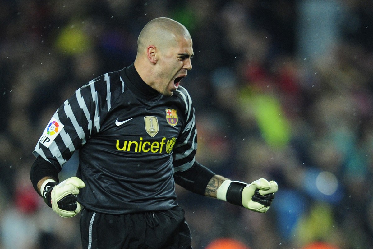 FC Barcelona's goalkeeper Victor Valdes reacts after David Villa scored against Real Madrid during a Spanish La Liga soccer match at the Camp Nou stadium in Barcelona, Spain, Monday, Nov. 29, 201 ...