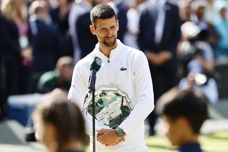epa11477913 Novak Djokovic of Serbia holds his runner up trophy after losing the Men&#039;s final against Carlos Alcaraz of Spain at the Wimbledon Championships, Wimbledon, Britain, 14 July 2024. EPA/ ...