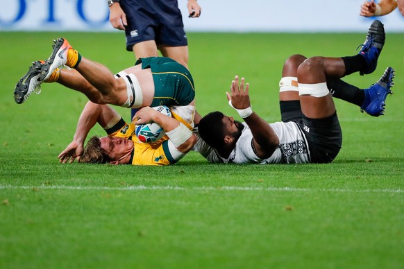 epa07858154 Michael Hooper (L) of Australia in action against Tevita Ratuva (R) of Fiji during the Rugby World Cup match between Australia and Fiji in Sapporo, Japan, 21 September 2019.The Rugby World ...