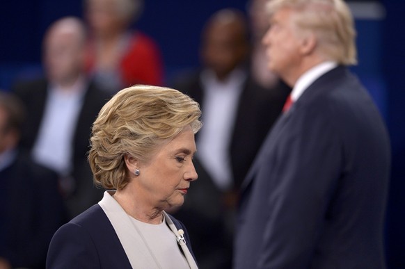 Republican U.S. presidential nominee Donald Trump and Democratic U.S. presidential nominee Hillary Clinton pause at the conclusion of their presidential town hall debate at Washington University in St ...