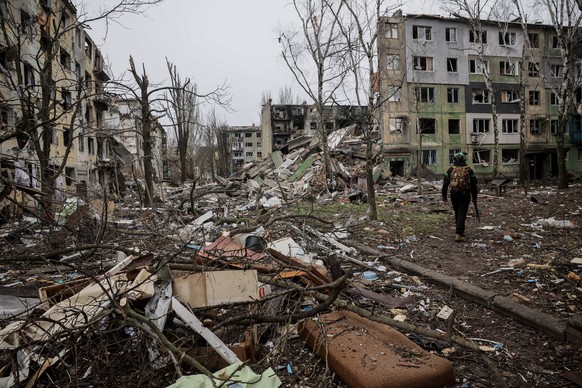 In this photo taken on Saturday Dec. 20, 2025 and provided by Ukraine's 24th Mechanized Brigade press service, a soldier walks through the ruins of the town of Kostyantynivka, in the Donetsk regi ...