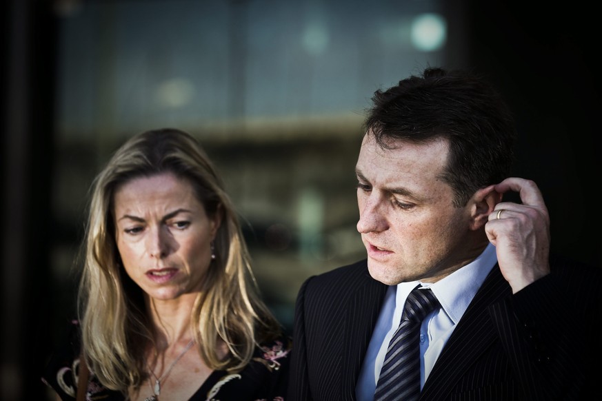 epa04305088 Gerry McCann (R) and Kate McCann (L) the parents of the missing British child Madeleine talk to the press after a court session for the libel case against former Portuguese police chief Go ...