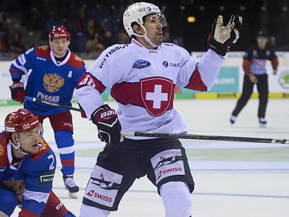 Russia&#039;s Nikolay Demidov, left, fights for the puck against Switzerland&#039;s Yannick-Lennart Albrecht, right, during the Ice Hockey Deutschland Cup match between Switzerland and Russia at the K ...