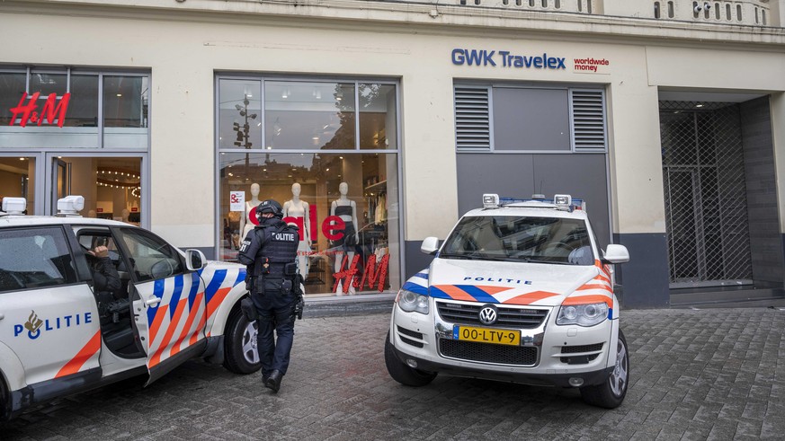 epa09336020 Police cars are seen in front of the building where RTL Boulevard studio is located on Leidseplein after it has been evacuated, in Amsterdam, the Netherlands, 10 July 2021. The broadcast o ...