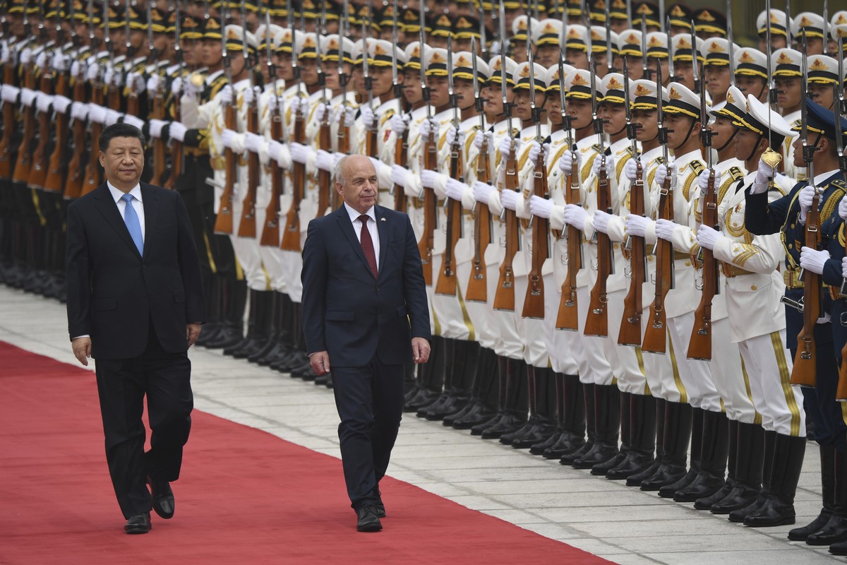 epa07535657 Switzerland’s President Ueli Maurer (C) and China's President Xi Jinping (L) review honor guards during a welcome ceremony at the Great Hall of the People in Beijing, China, 29 April  ...