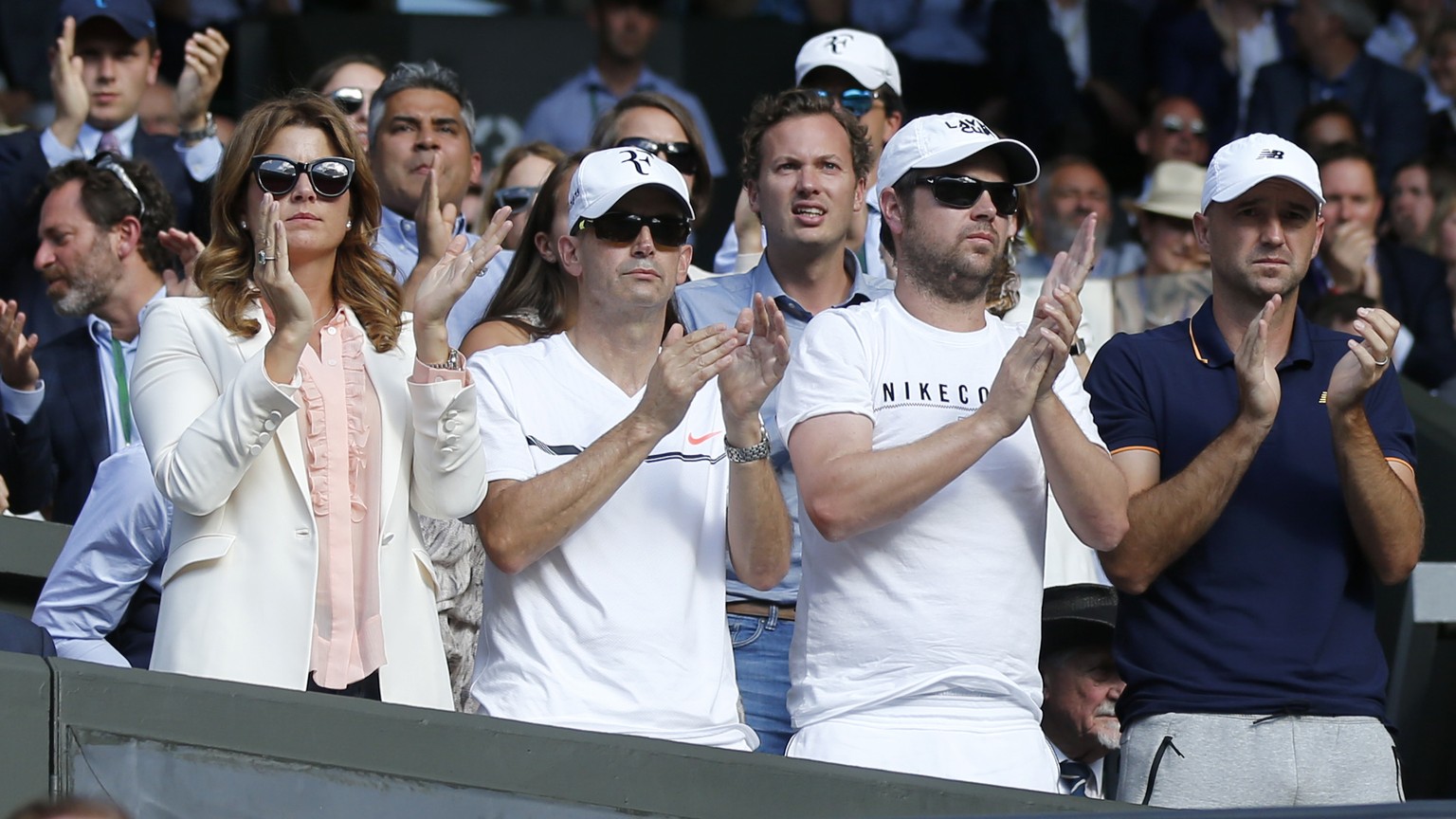 Roger Federer&#039;s wife Mirka, Daniel Troxler, Severin Luethi and Ivan Ljubicic, from left, react during the quarter final match of Roger Federer of Switzerland against Milos Raonic of Canada, durin ...