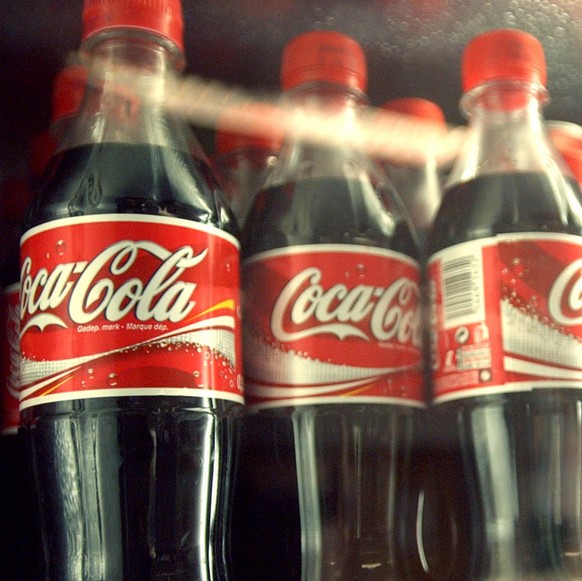 Coca-Cola cans and bottles are seen in a cooler at European Commission headquarters in Brussels, Tuesday Oct. 19, 2004. The European Union reached a settlement Tuesday of its long-running antitrust ca ...