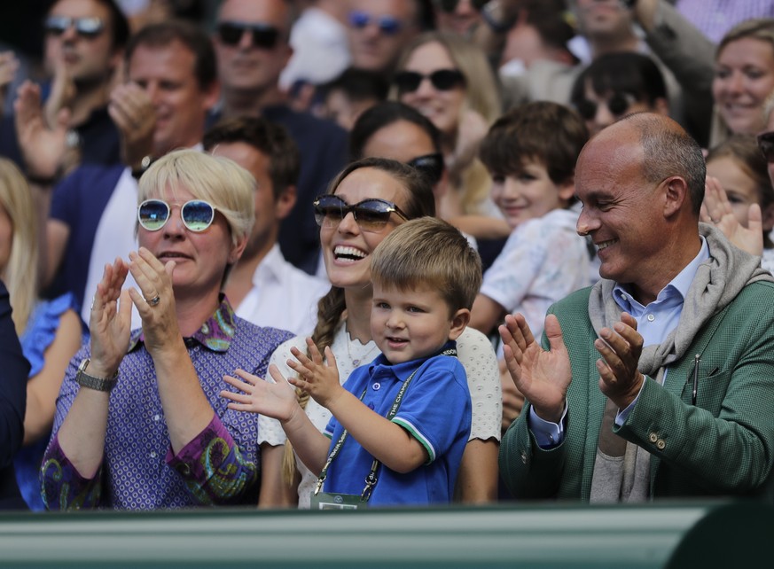 Jelena Djokovic, wife of Novak Djokovic of Serbia and their son applaud after the men&#039;s singles final match against Kevin Anderson of South Africa at the Wimbledon Tennis Championships in London, ...
