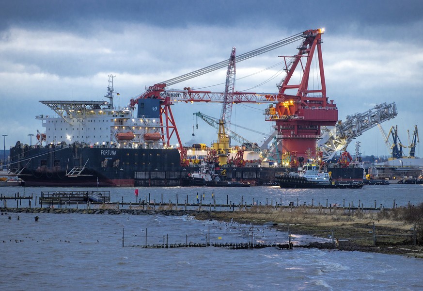 Tugboats get into position on the Russian pipe-laying vessel &quot;Fortuna&quot; in the port of Wismar, Germany, Thursday, Jan 14, 2021. The special vessel is being used for construction work on the G ...