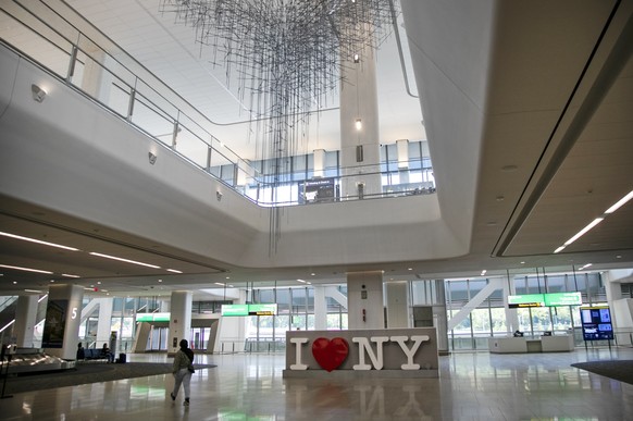 A woman walks in the baggage claim area inside Terminal B at LaGuardia Airport Wednesday, July 15, 2020, in New York. (AP Photo/Frank Franklin II)