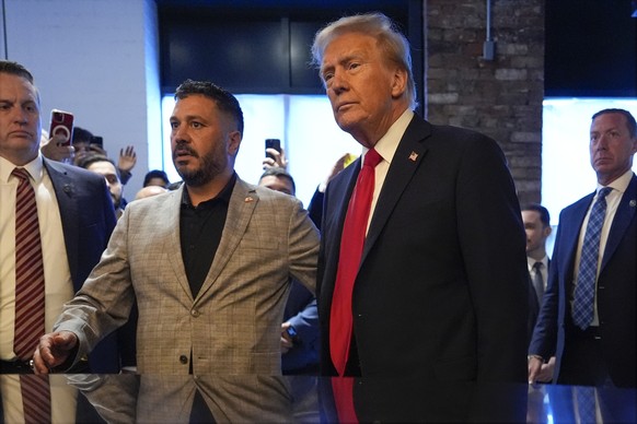 Republican presidential nominee former President Donald Trump talks as he visits The Great Commoner, Friday, Nov. 1, 2024, in Dearborn, Mich., as owner Albert Abbas watches. (AP Photo/Julia Demaree Ni ...