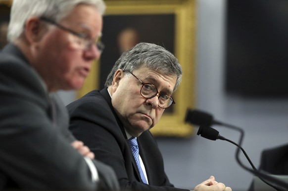 Attorney General William Barr looks over toward Assistant Attorney General for Administration, Lee J. Lofthus, left, as they appear before a House Appropriations subcommittee, on Capitol Hill, Tuesday ...