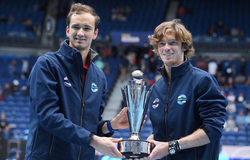 epa08992960 Team Russia players Daniil Medvedev (L) and Andrey Rublev (R) hold the trophy after winning the ATP Cup final against Team Italy on Rod Laver Arena at Melbourne Park in Melbourne, Australi ...