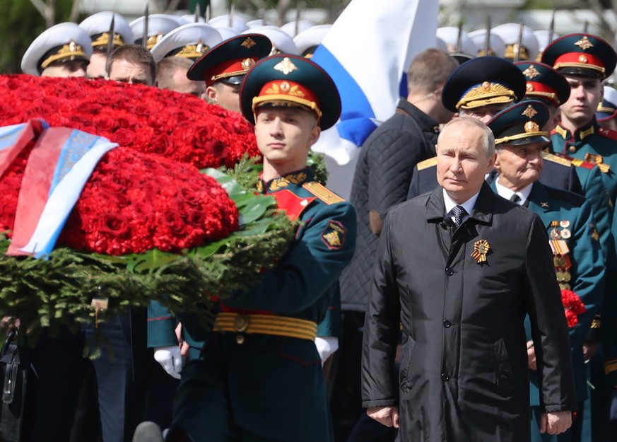epa09935520 Russian President Vladimir Putin (front R) attends a flower-laying ceremony at the Tomb of the Unknown Soldier by the Kremlin wall after the Victory Day military parade in Moscow, Russia,  ...