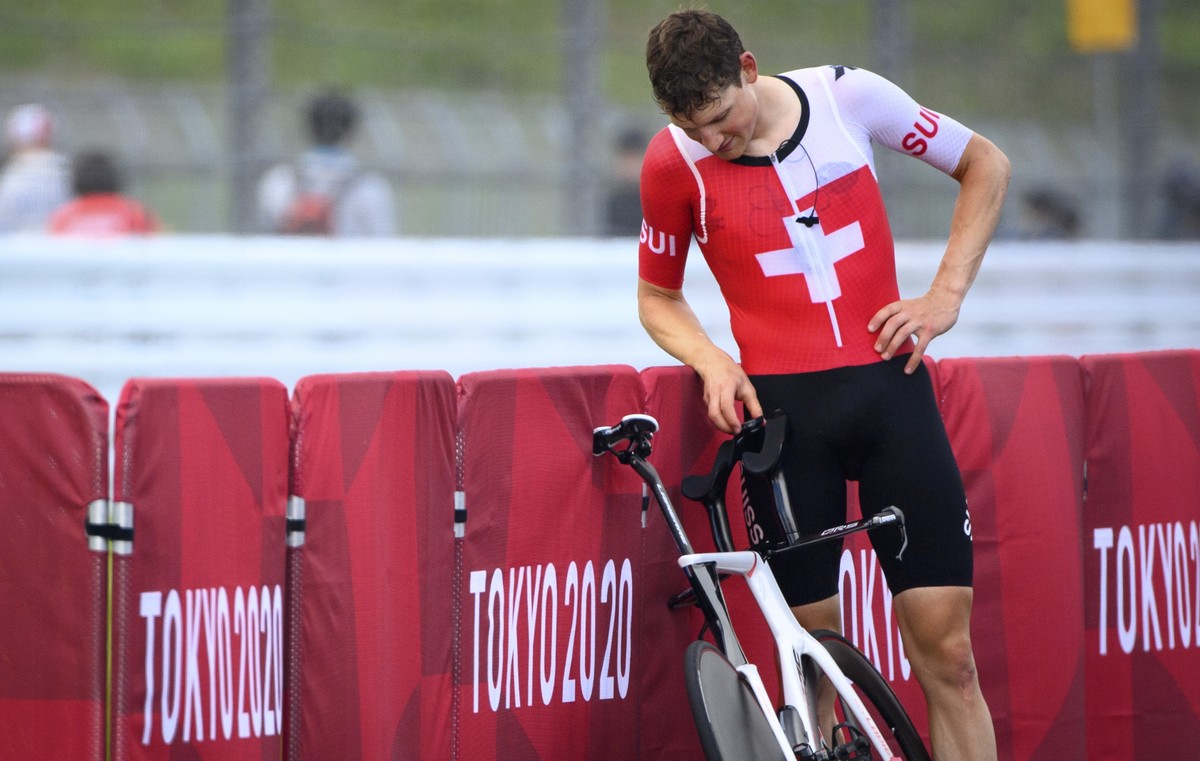 epa09373020 Fourth placed Stefan Kueng of Switzerland reacts after crossing the finish line during the Men's cycling individual time trial at the Tokyo 2020 Olympic Games at the Fuji Internationa ...
