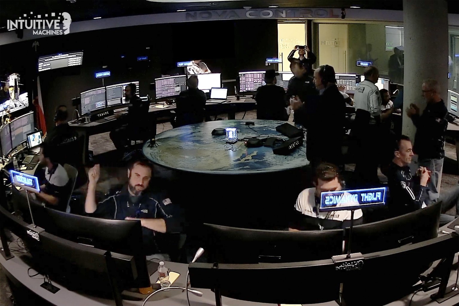 An image taken from video released by Intuitive Machines shows flight controllers at Intuitive Machines in Houston react after its private spacecraft touched down on the moon on Thursday, Feb. 22, 202 ...