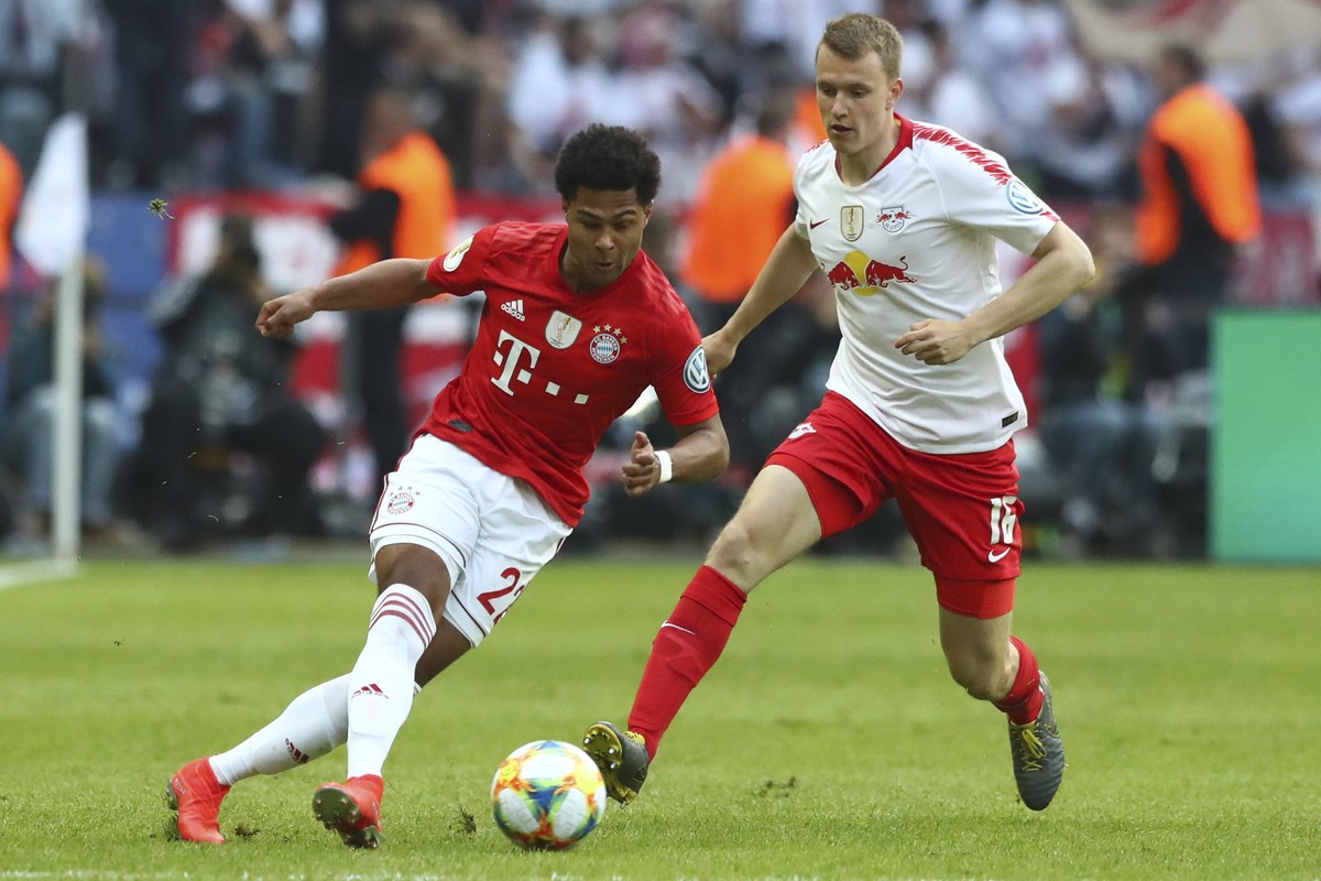 Leipzig's Lukas Klostermann, right, fights for the ball with Bayern's Serge Gnabry during the German soccer cup, DFB Pokal, final match between RB Leipzig and Bayern Munich at the Olympic st ...