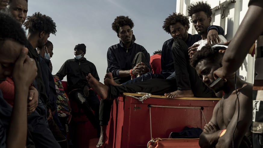 Some of the migrants rescued from the sea are seen on board of the humanitarian ship Ocean Viking cruising in the Mediterranean Sea, Wednesday, Nov. 9, 2022. The SOS Mediterranee humanitarian group sa ...