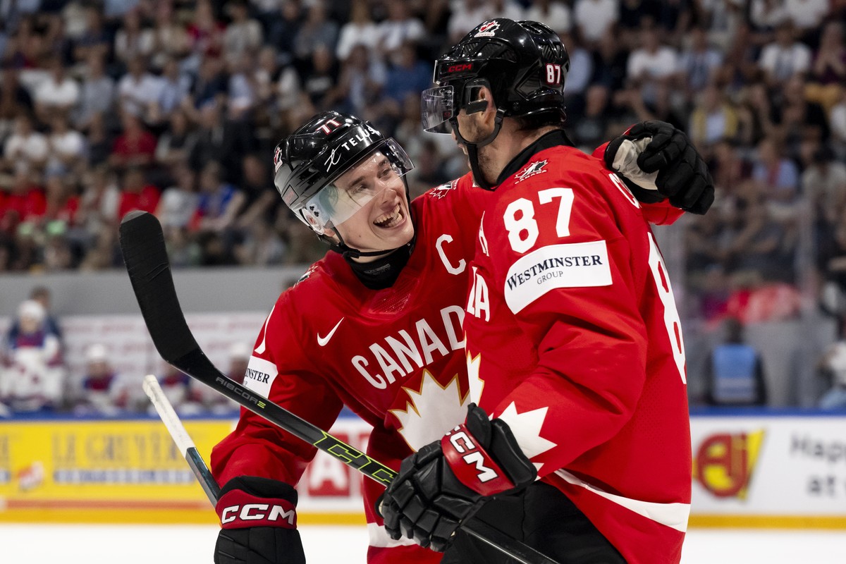 epa13000832 Canada's Sidney Crosby (R) celebrates scoring the 4-0 goal with teammate Macklin Celebrini during the 2026 IIHF Men's Ice Hockey World Championship quarter-finals game between Ca ...