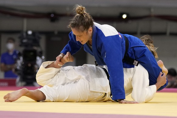 Fabienne Kocher of Switzerland, top, and Ana Perez Box of Spain compete during their women's -52kg round of 32 judo match at the 2020 Summer Olympics, Sunday, July 25, 2021, in Tokyo, Japan. (AP Photo ...