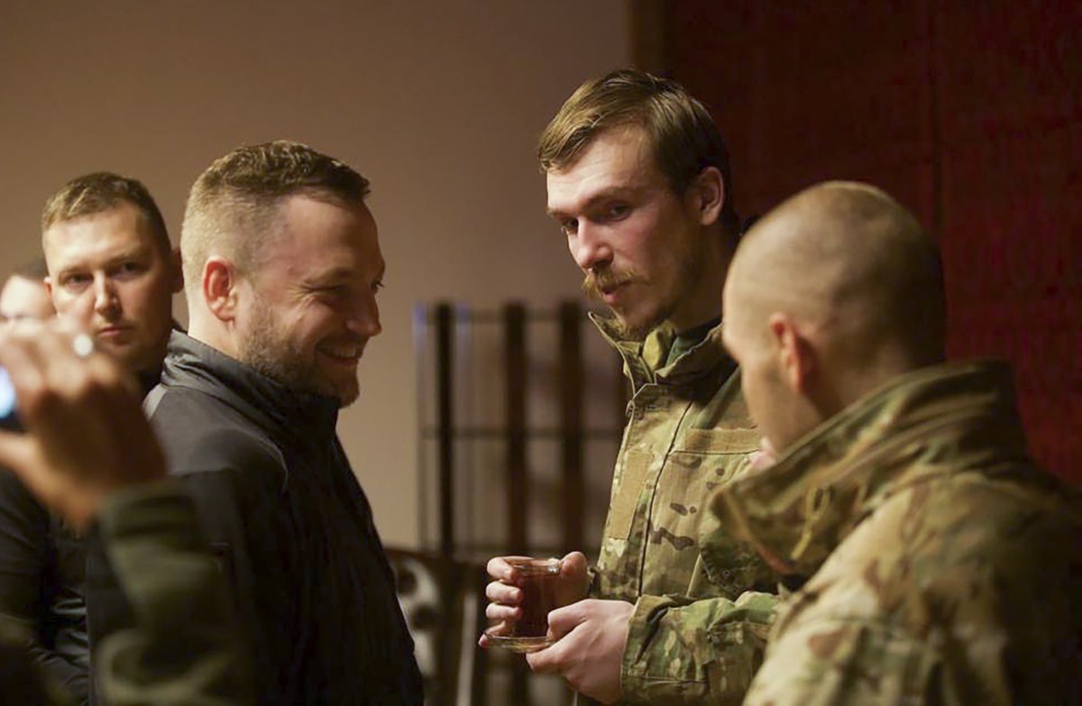 In this photo provided by the Ukrainian Interior Ministry Press Office, Ukrainian Interior Minister Denys Monastyrsky, second left, talks with Azov regiment commander Denys Prokopenko, second right, w ...