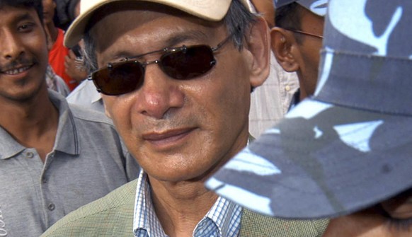 FILE - Police escort of convicted French serial killer Charles Sobhraj from court in Kathmandu, Nepal on August 12, 2004. Known serial killer Sobhraj, who was sentenced to life in prison i...