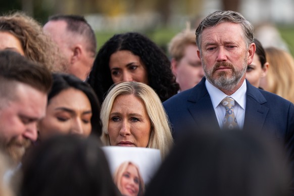 Rep. Marjorie Taylor Greene, R-Ga., second from right, and Rep. Thomas Massie, R-Ky., right, react during a news conference on the Epstein Files Transparency Act, Tuesday, Nov. 18, 2025, outside the U ...