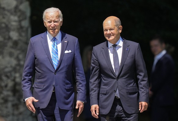 FILE - German Chancellor Olaf Scholz, right, and US President Joe Biden arrive for the official welcoming ceremony of the G7 Summit at Castle Elmau in Kruen, near Garmisch-Partenkirchen, Germany, June 26, 2…