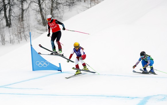 epa09764776 (L-R) Fanny Smith of Switzerland, Andrea Limbacher of Austria and Natalia Sherina of Russia in action during the Women's Freestyle Skiing Ski Cross 1/8 final at the Zhangjiakou Genting Snow Park at the Beijing 2022 Olympic Games, Zhangjiakou, China, 17 February 2022.  EPA/MAXIM SHIPENKOV