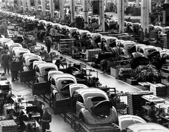 FILE - In this June 16, 1954 file photo, VW beetles are assembled in lines at the Volkwagen auto works plant, which manufactures nearly 900 automobiles each day, in Wolfsburg, West Germany. Thanks to  ...