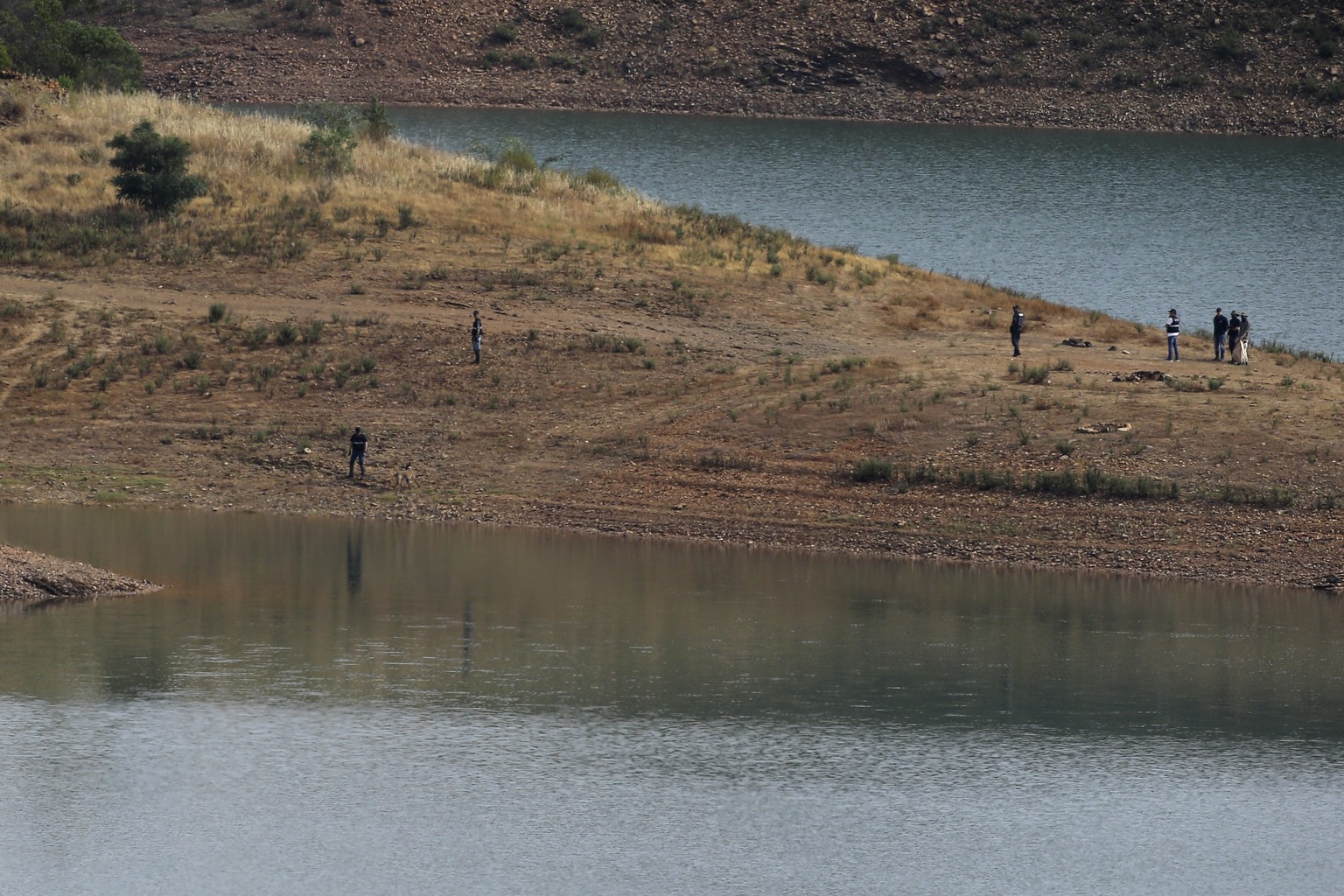Police work on the banks of the Arade dam near Silves, Portugal, Tuesday, May 23, 2023. Portuguese police said they are continuing the search for Madeleine McCann, the British toddler who disappeared in the…