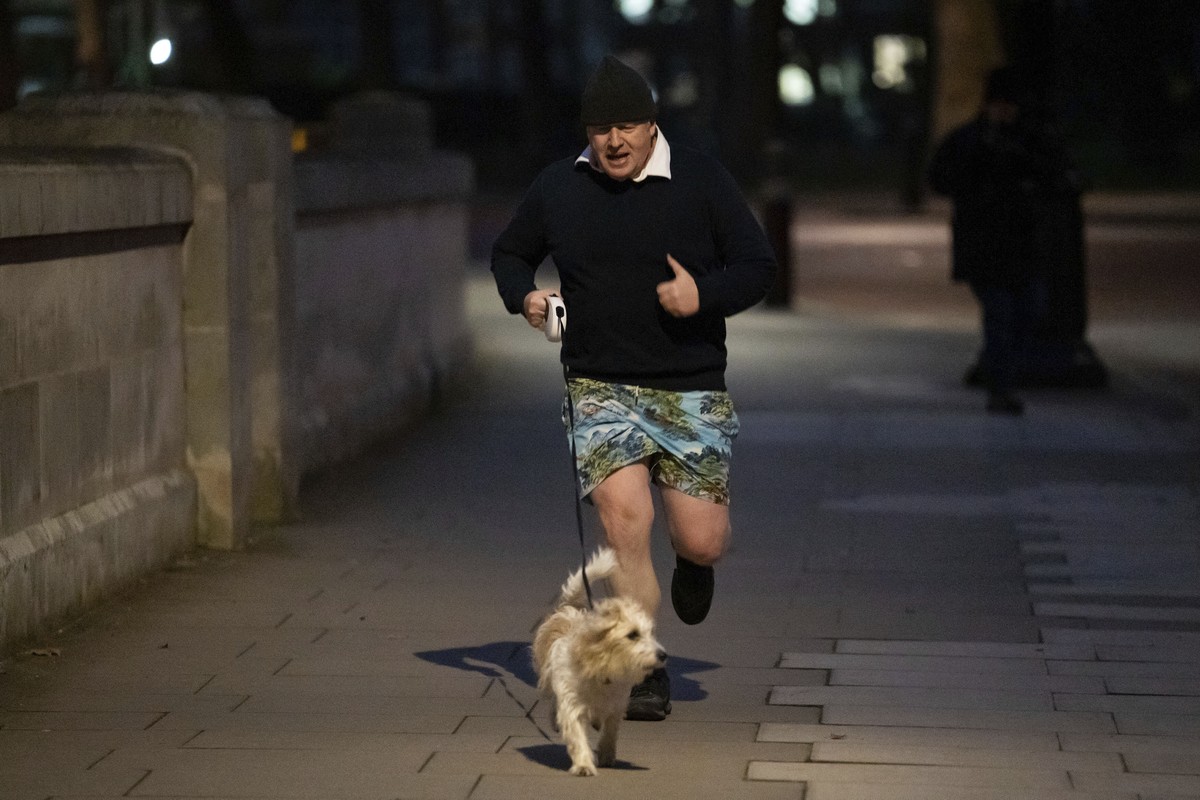 Britain's Prime Minister Boris Johnson jogs in central London, early Monday, Jan. 24, 2022. (Aaron Chown/PA via AP)