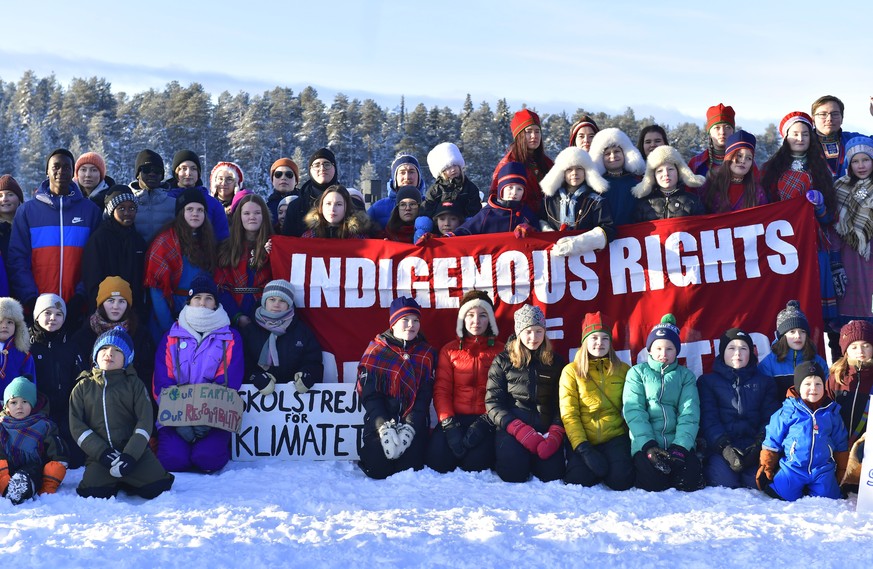 FILE - Swedish climate activist Greta Thunberg, front center left, takes part in a climate strike with Sami children in Jokkmokk, Sweden, Feb. 7, 2020. Two independent U.N. human rights experts called ...