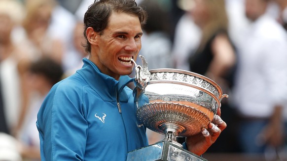Spain&#039;s Rafael Nadal bites the cup the after defeating Austria&#039;s Dominic Thiem in the men&#039;s final match of the French Open tennis tournament at the Roland Garros stadium, Sunday, June 1 ...