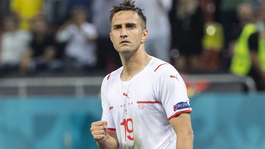 Switzerland&#039;s forward Mario Gavranovic reacts after scoring the first penalty during the Euro 2020 soccer tournament round of 16 match between France and Switzerland at the National Arena stadium ...
