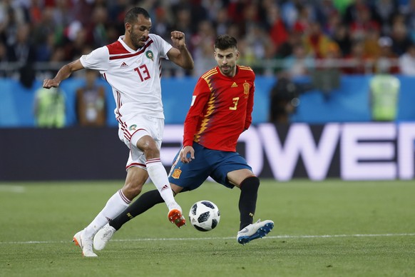 Morocco&#039;s Khalid Boutaib, left, and Spain&#039;s Gerard Pique challenge for the ball during the group B match between Spain and Morocco at the 2018 soccer World Cup at the Kaliningrad Stadium in  ...