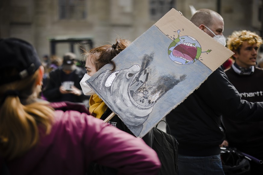 Protesters take part in a climate strike rally calling for work hours to be reduced, in Zurich, Switzerland, on Saturday, April 9, 2022. The movement sees a reduction of working hours as a contributio ...