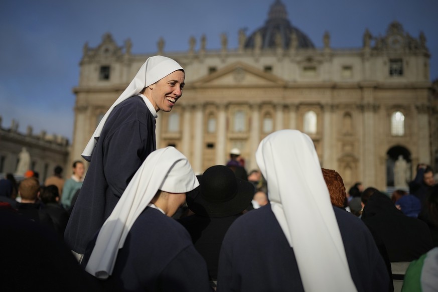 KEYPIX - Nuns share a laugh as people gather for the funeral of Pope Francis in St. Peter&#039;s Square at the Vatican, Saturday, April 26, 2025. (AP Photo/Andreea Alexandru)