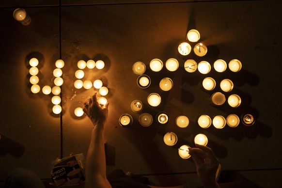 People light candles in memory of the 45 ultra-Orthodox Jews killed in a stampede at a religious festival on Friday, during a candle-light vigil in Tel Aviv, Israel, Saturday, May 1, 2021. The stamped ...