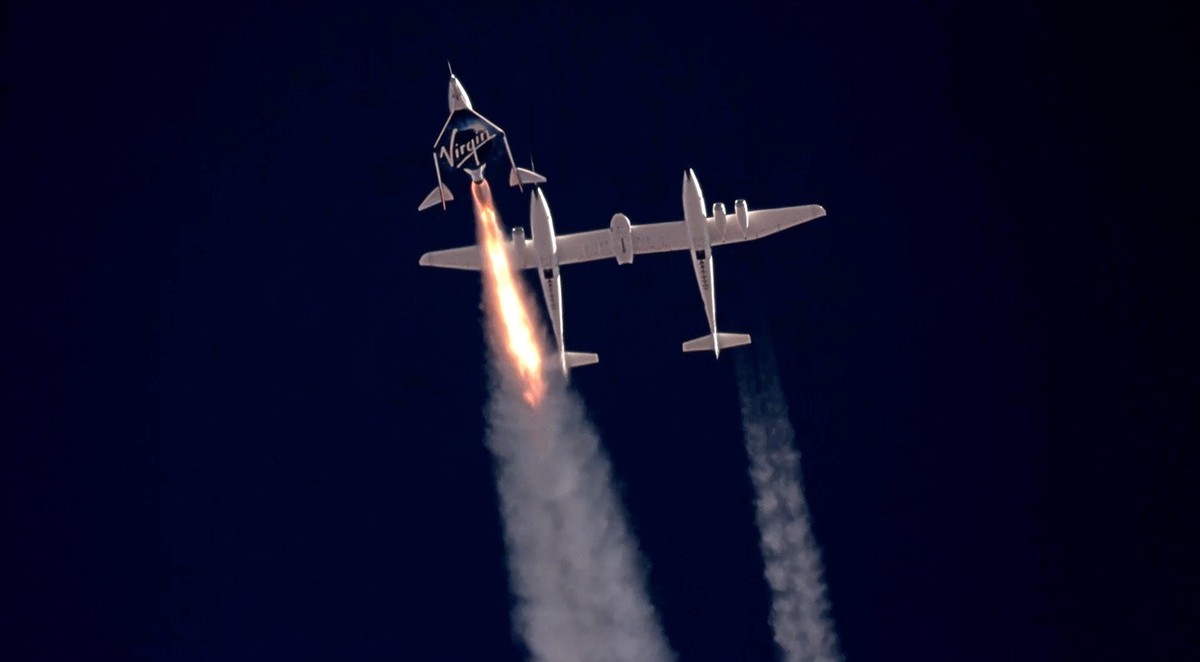 epa09339457 A framegrab from a video made available by Virgin Galatic shows SpaceShip Two Unity 22 under thrust heading towards space after separating from the carrier plane (R) above Spaceport Americ ...