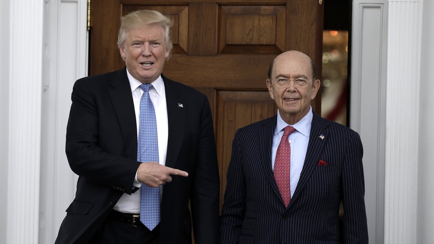 epa06310532 (FILE) - US President-elect Donald Trump (L) gestures at investor Wilbur Ross at the clubhouse of Trump International Golf Club, in Bedminster Township, New Jersey, USA, 20 November 2016 ( ...