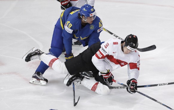 Sweden&#039;s Victor Rask, left, checks Switzerland&#039;s Reto Schappi, right, during the Ice Hockey World Championships quarterfinal match between Switzerland and Sweden in the AccorHotels Arena in  ...