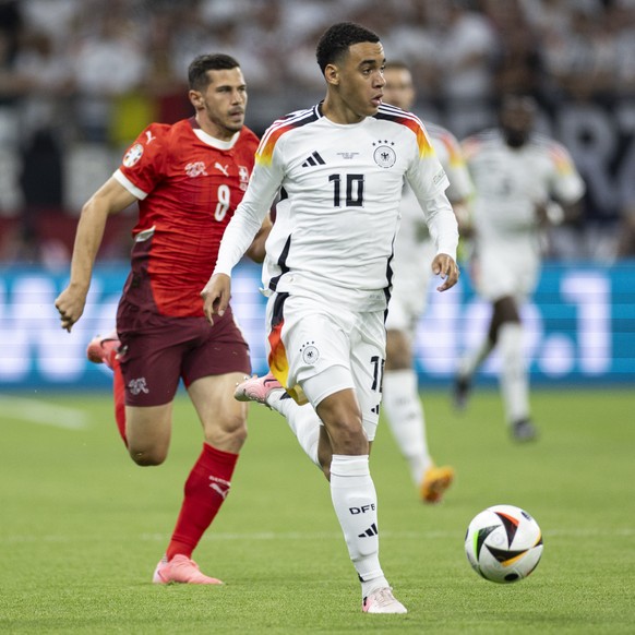 epa11432915 Switzerland&#039;s Remo Freuler, left, and Germany&#039;s Jamal Musiala, right, in action during the UEFA EURO 2024 Group soccer A match between Switzerland and Germany, in Frankfurt am Ma ...