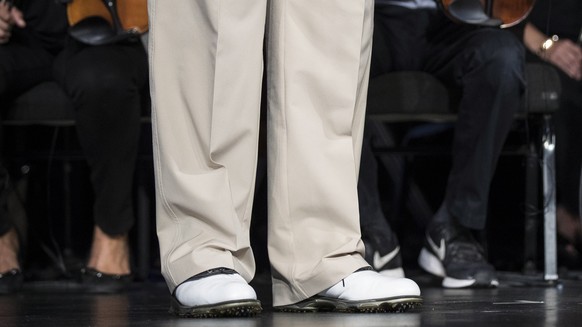 epa07620854 US President Donald J. Trump wears golf shoes during a surprise visit to McLean Bible Church in Vienna, Virginia, USA, 02 June 2019 where the pastor David Platt (not pictured) prayed for h ...
